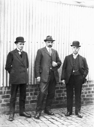 Three suited gents possibly from Allen & Dey.