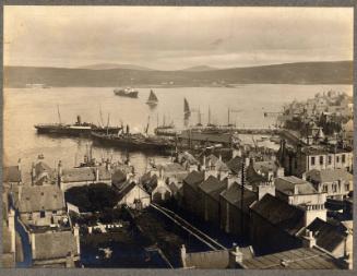 Black and white photograph looking across Lerwick to Victoria Pier and across to Bressay.  Earl…
