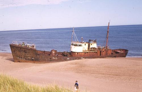 unidentified trawler aground on a beach