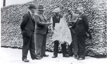 Two Identical Black and white photographs Showing Men Examining A Big Driedsalt Fish At William…