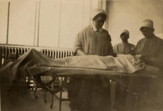 Nurse Marget Husband Standing by Patient at Casualty Department Aberdeen Royal Infirmary