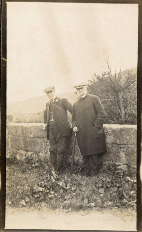 Men leaning against a wall