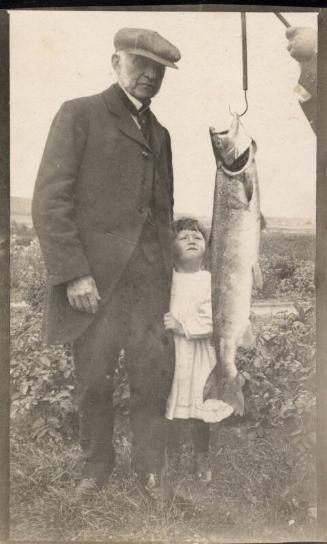 Man with little girl and fish