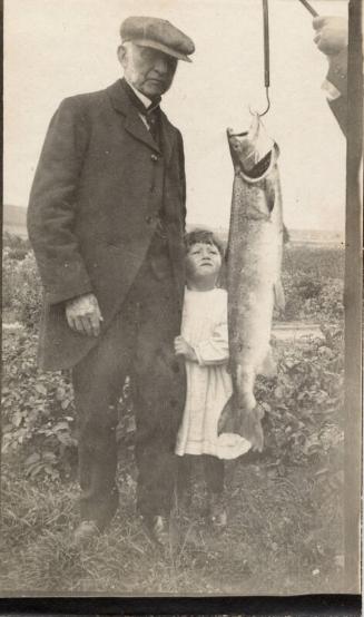 Man with little girl and fish