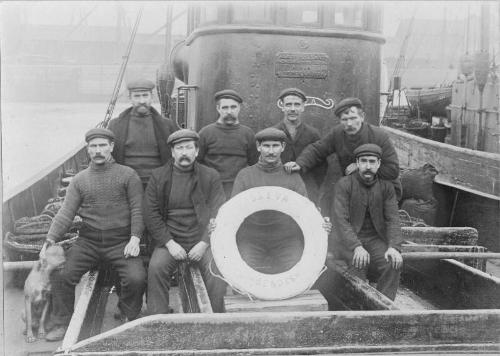 Black and white photograph showing the crew of 'Eva' (and dog)