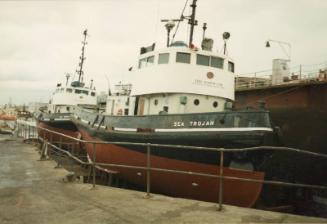 Colour photograph showing the Aberdeen Harbour Tug 'Sea Trojan' in dry dock, after its sale