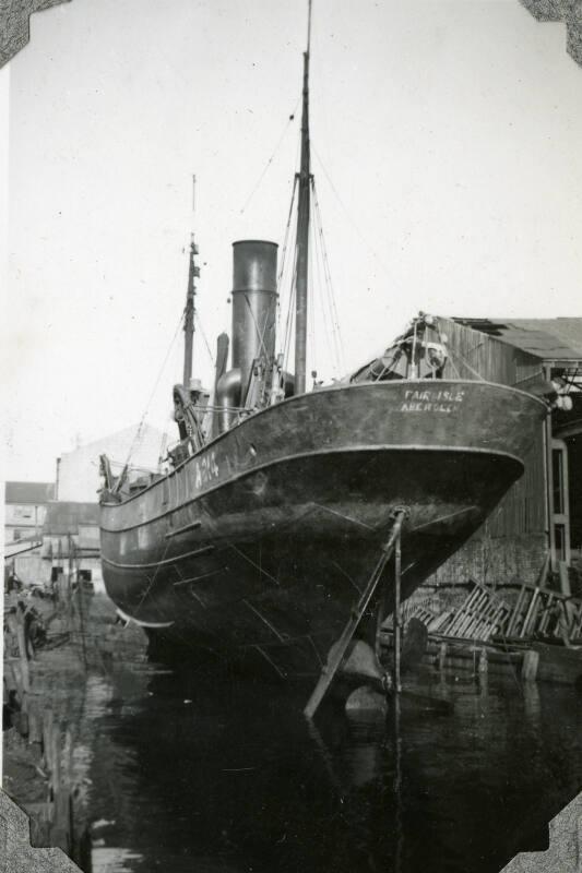 Black and White Photograph in album of steam trawler 'Fair Isle' (A214) up on stocks in harbour