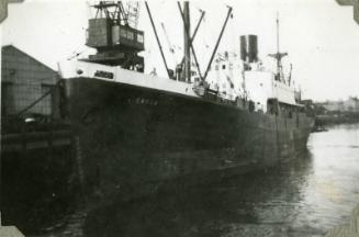 Black and White Photograph in album of ship 'Carlo' at dockside