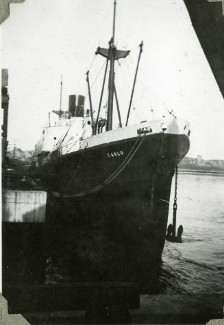 Black and White Photograph in album of ship 'Carlo' at dockside