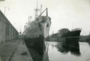 Black and White Photograph in album of ship 'Aberdonian Coast' being repainted at dockside