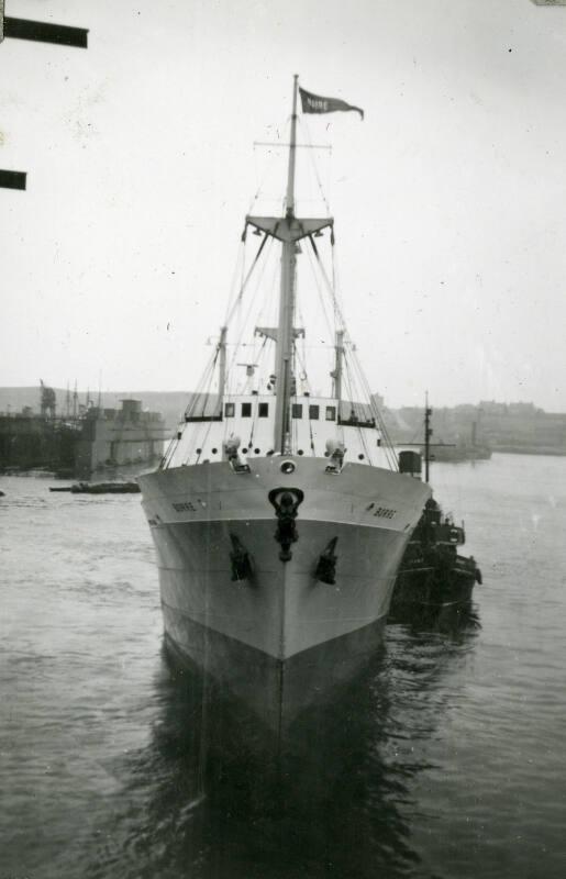 Black and White Photograph in album of 'Borre' under tow in harbour