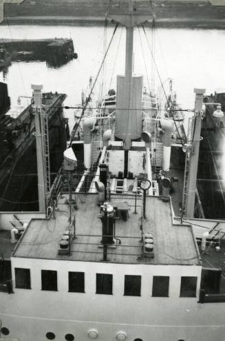 Black and White Photograph in album of 'Borre' under tow in harbour