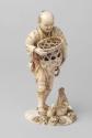 Japanese Carved Okimono Figure of a Man with Rabbits