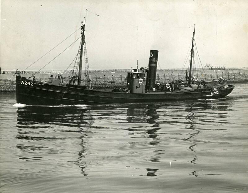 Black and white photograph showing the Port Side Of The Trawler A242 Ben Heilem Entering Aberdeen Harbour