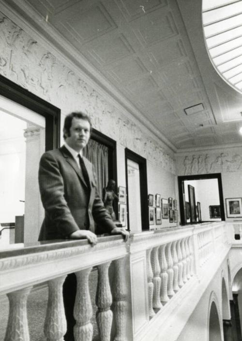 Director of Art Gallery Ian McKenzie Smith on Balcony in Gallery