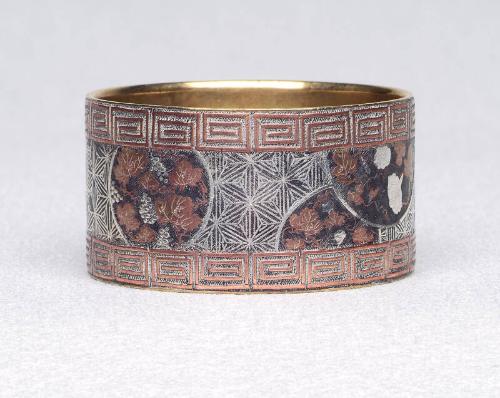 Inlaid napkin ring with greek key and vine pattern