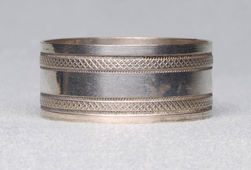 Pair of narrow napkin rings with machine tooling