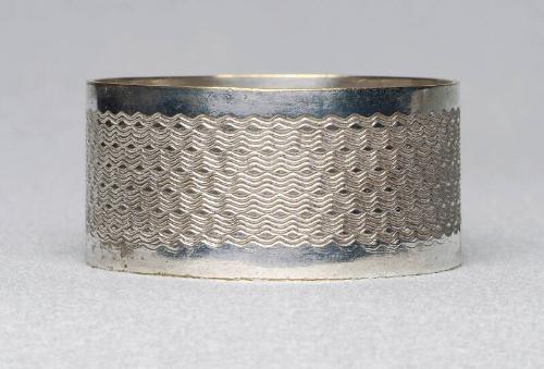 Silver plated napkin ring with machine tooling.