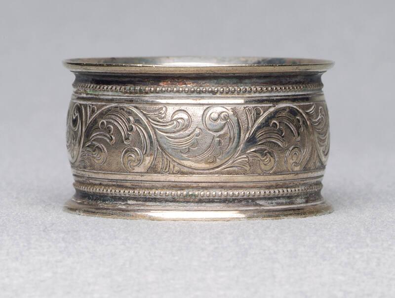 Silver plated napkin ring with engraved floral band