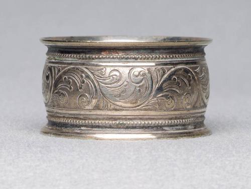 Silver plated napkin ring with engraved floral band