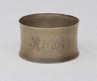 Silver plated brass napkin ring with crimped edges.