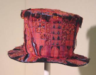 Red, blue and black silk top hat in slashed fabric by Jilli Blackwood