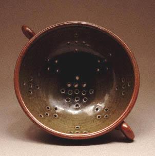 Brown saltglaze colander by Sheila Casson