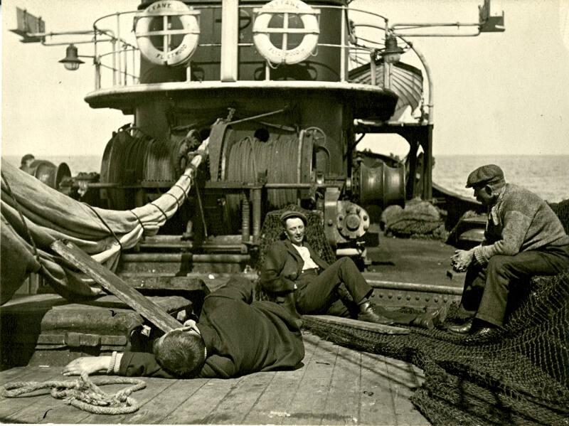 Black and white photograph showing crew lying around on deck