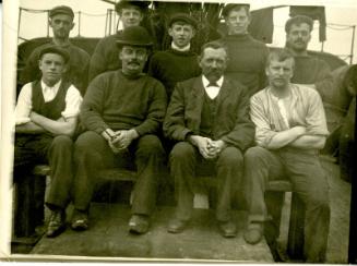 Black and white photograph showing crew, seated
