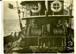 Black and white photograph showing crew members and winches