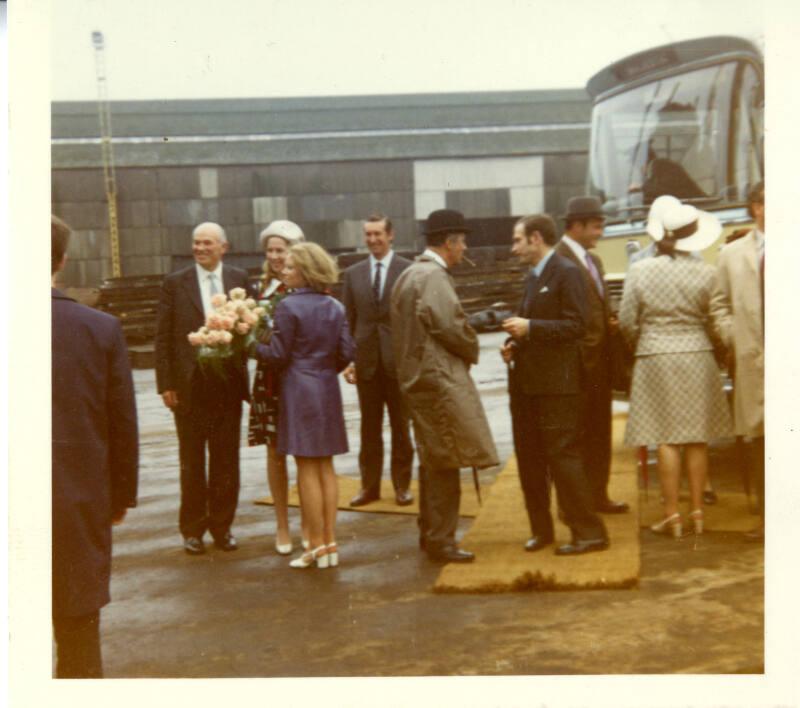 Colour photograph showing launch party arriving by bus