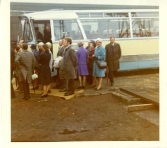 Colour photograph showing launch party for GODETIA disembarking from bus