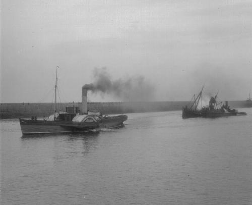 the paddle tug 'Granite City' towing an unidentified vessel, with another vessel, which seems t…