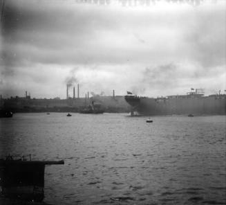 large steamship (Intaba?) being launched at Aberdeen Harbour, with paddle tug also visible