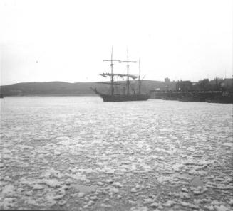 fishing vessels and a large steam yacht in what appears to be Aberdeen harbour, lots of ice in …