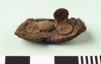 Copper alloy studs in fragment of leather from Rattray