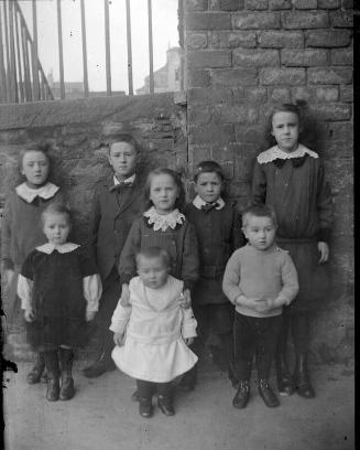 Group of eight children outdoors.