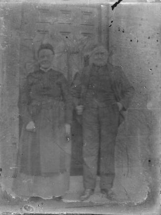 Man and woman standing on outside step of doorway