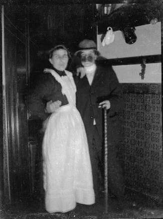Man and Woman Standing Indoors