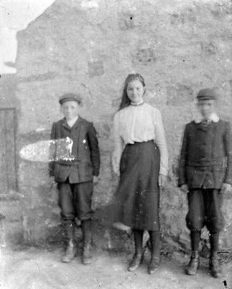 Two Boys and Girl Standing Outdoors