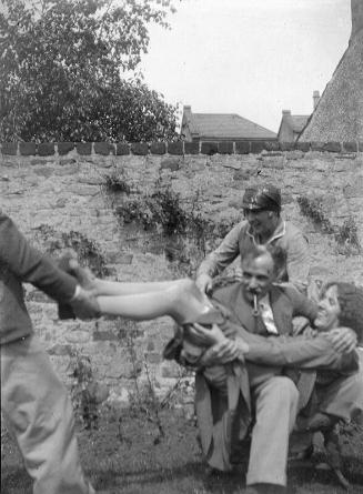 Man Holding Woman  Across his Knee