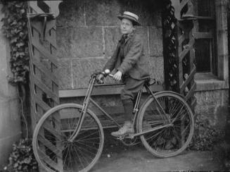 Boy Seated on Bicycle