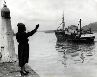 Waving farewell to the crew of Blue Mist II, Lewis built motor trawler, leaving Aberdeen for St…