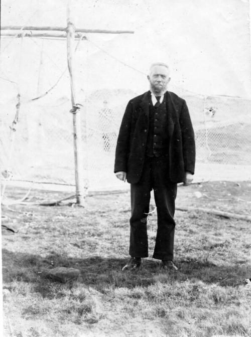 Man standing in front of fishing nets