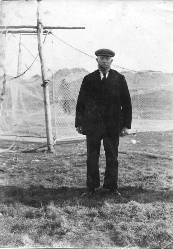 Man standing in front of fishing nets