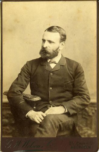 Studio Photograph of Man Seated
