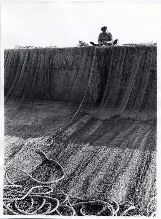 Man Seated Mending Nets Black & White Photograph by Fay Godwin