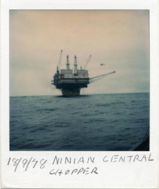 Colour Photograph Showing The Ninian Central Oil Platform With A Helicopter Approaching