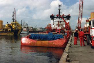 Colour Photograph Showing An Unknown Supply Vessel From Astern, Deck Loaded With Tubes