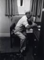 Man at A Desk, Black & White Photograph by Fay Godwin